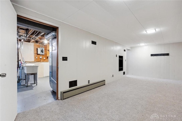 basement featuring a baseboard radiator and electric panel