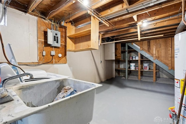 basement featuring sink, gas water heater, and electric panel