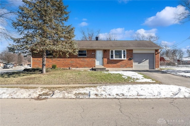 single story home with a garage and a front lawn