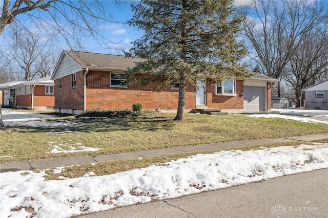 view of front of property featuring a garage and a lawn