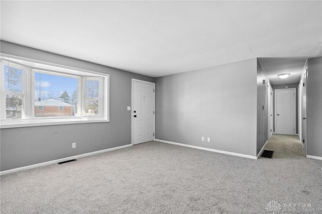 unfurnished room with light colored carpet