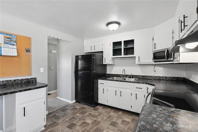 kitchen featuring sink, electric range, white cabinets, and black fridge