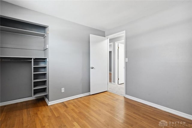 unfurnished bedroom featuring hardwood / wood-style flooring and a closet