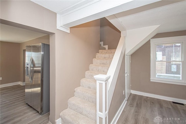 stairway with hardwood / wood-style floors