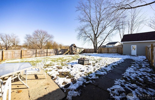 snowy yard with a playground