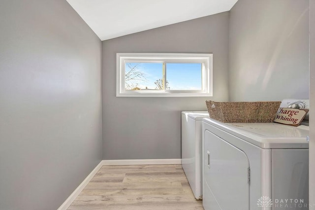 washroom with washer and dryer and light wood-type flooring