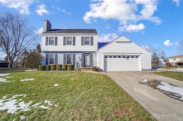 colonial inspired home with a garage and a front yard