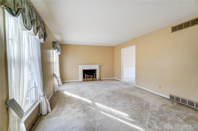 unfurnished living room featuring light carpet