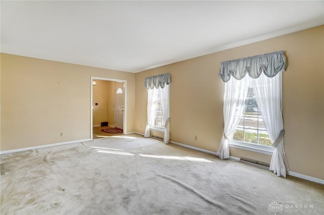 carpeted empty room featuring a wealth of natural light