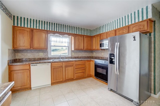 kitchen featuring sink, backsplash, and appliances with stainless steel finishes