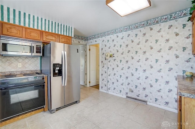 kitchen featuring light tile patterned flooring, appliances with stainless steel finishes, and decorative backsplash