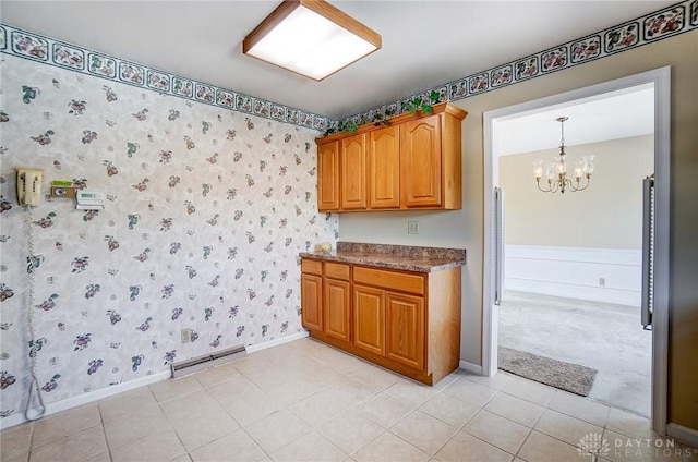 kitchen featuring an inviting chandelier, hanging light fixtures, and light tile patterned flooring