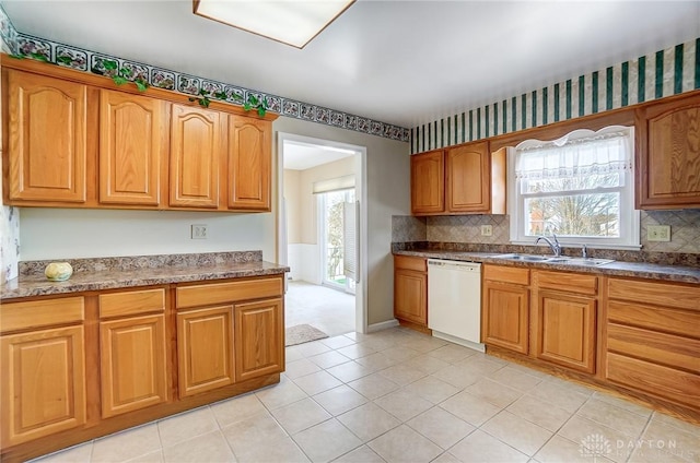 kitchen with backsplash, dishwasher, sink, and a wealth of natural light