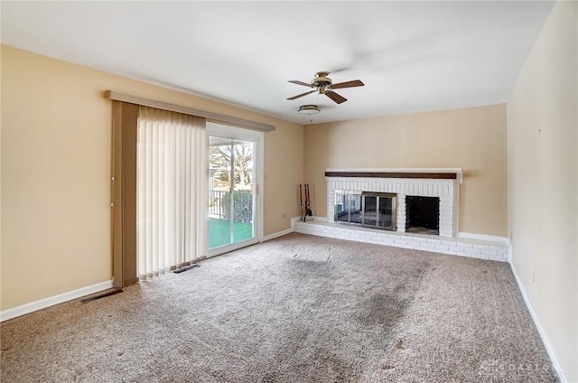 unfurnished living room featuring ceiling fan, carpet floors, and a fireplace