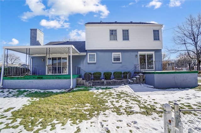 snow covered property featuring covered porch