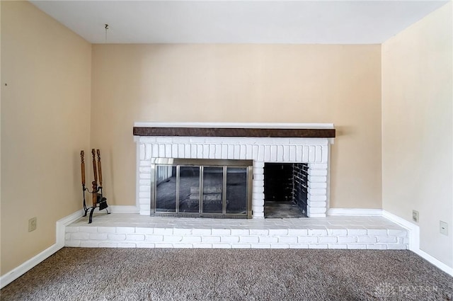 room details featuring a brick fireplace and carpet flooring