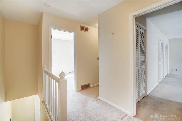 hallway with light colored carpet