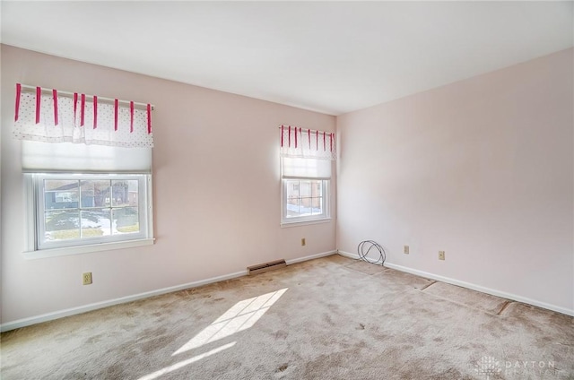 unfurnished room with light carpet