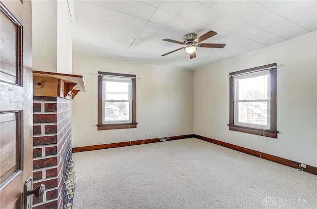 carpeted spare room with ceiling fan