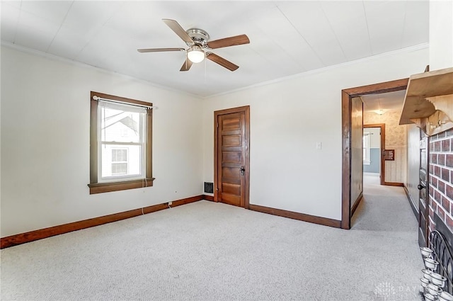 carpeted empty room featuring ornamental molding and ceiling fan