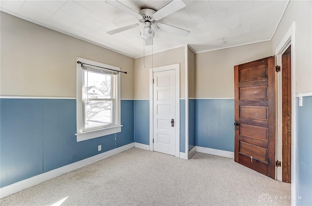 unfurnished bedroom featuring ceiling fan and light carpet