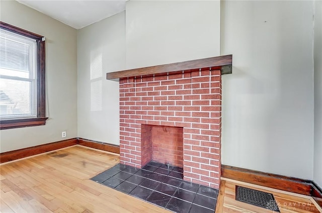 interior details featuring wood-type flooring and a fireplace