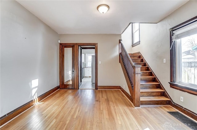 foyer entrance with light hardwood / wood-style floors