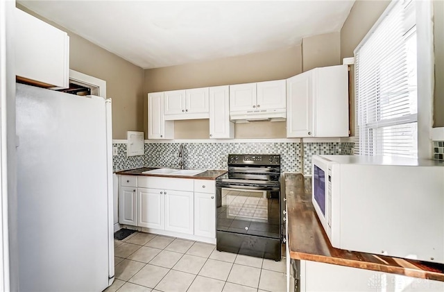 kitchen with sink, white cabinetry, tasteful backsplash, light tile patterned floors, and white appliances