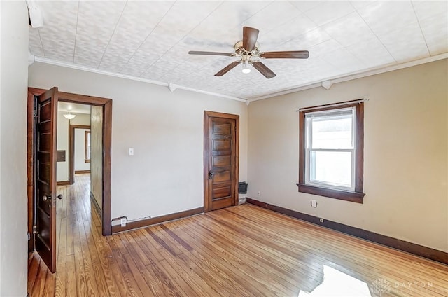 spare room featuring crown molding, ceiling fan, and light hardwood / wood-style flooring