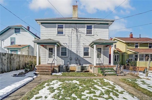 rear view of property with cooling unit