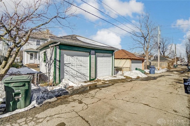 view of side of property with a garage and an outdoor structure