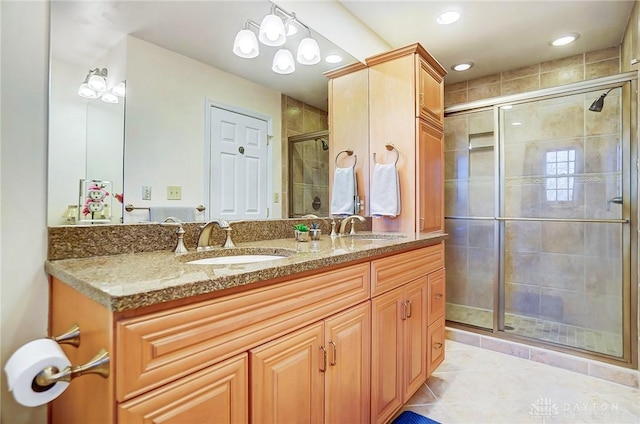 bathroom featuring vanity, an enclosed shower, and tile patterned floors