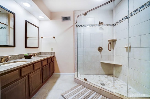 bathroom featuring vanity, tile patterned flooring, and a shower with door