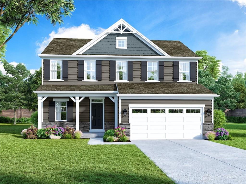 craftsman inspired home featuring a garage and a front yard