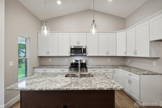 kitchen featuring pendant lighting, stainless steel appliances, and white cabinets