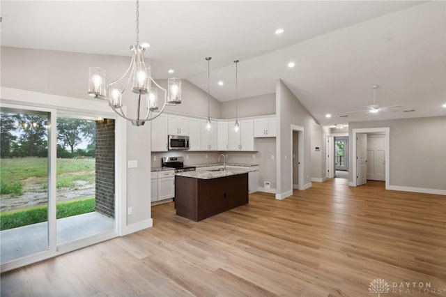 kitchen featuring sink, white cabinetry, decorative light fixtures, a center island with sink, and appliances with stainless steel finishes