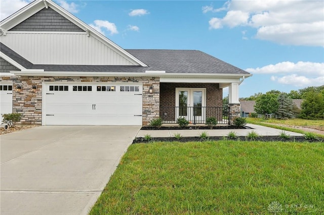 craftsman-style house with a garage, covered porch, and a front yard