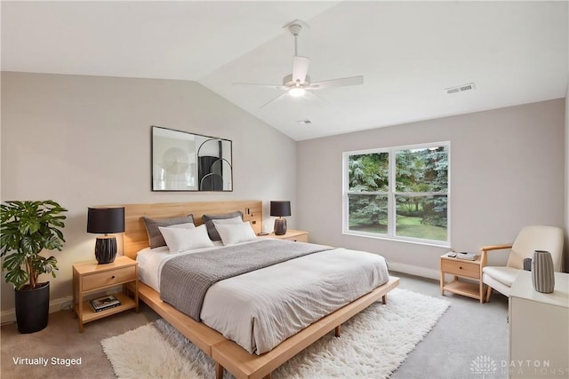 bedroom with ceiling fan, lofted ceiling, and carpet floors