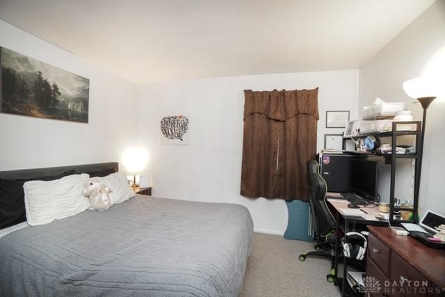 bedroom featuring light carpet