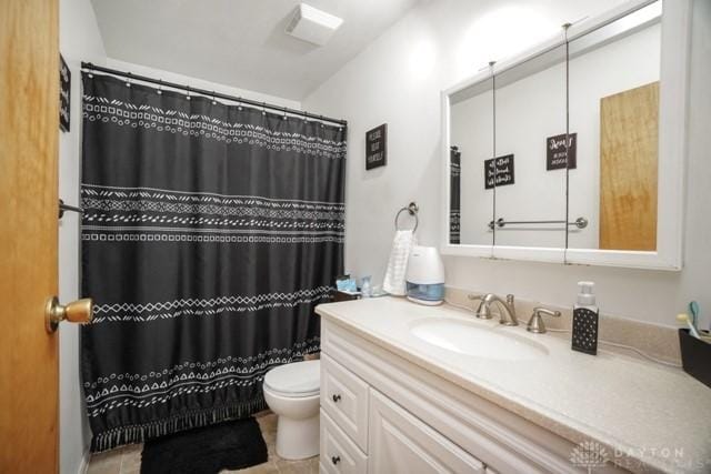 bathroom featuring vanity, toilet, and walk in shower