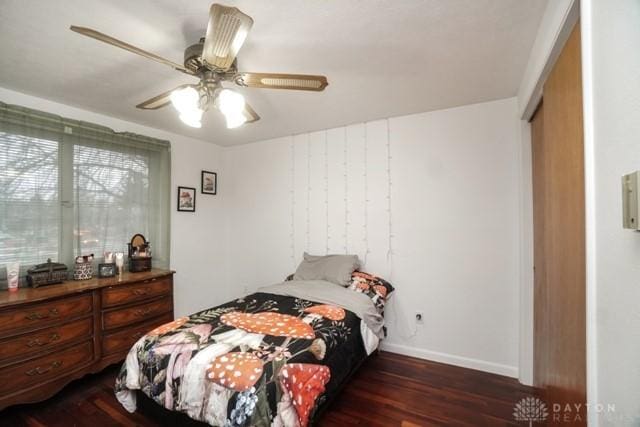 bedroom with dark wood-type flooring and ceiling fan