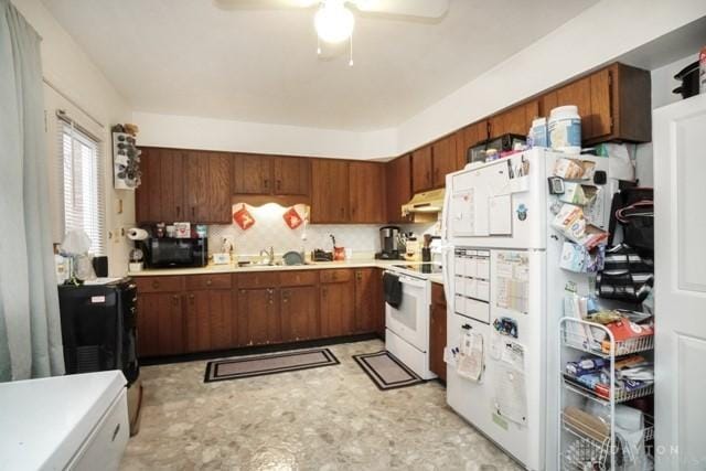 kitchen with tasteful backsplash, sink, white appliances, and ceiling fan