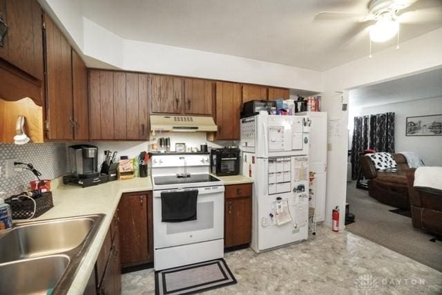 kitchen featuring sink, white appliances, ceiling fan, and backsplash