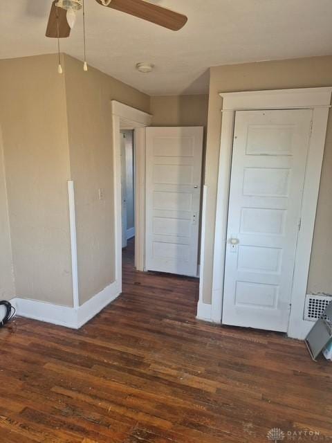 interior space with dark hardwood / wood-style floors and ceiling fan