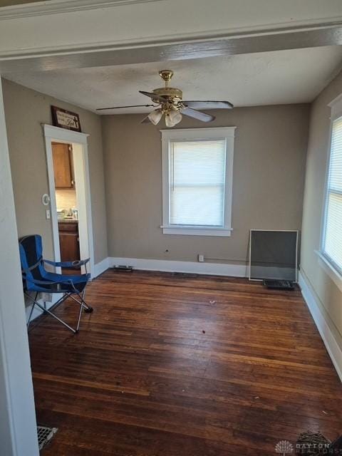 unfurnished room with dark hardwood / wood-style floors and ceiling fan