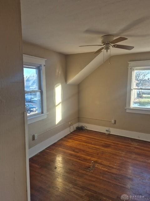 bonus room with ceiling fan, dark hardwood / wood-style floors, vaulted ceiling, and a wealth of natural light