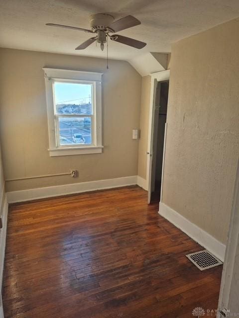 bonus room featuring dark hardwood / wood-style flooring, vaulted ceiling, and ceiling fan