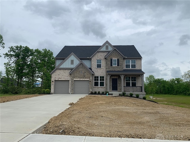 6529 Devon Dr, Liberty Twp, OH 45044 - craftsman inspired home with a porch, driveway, a garage, brick siding, and board and batten siding