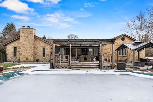 snow covered property with a deck