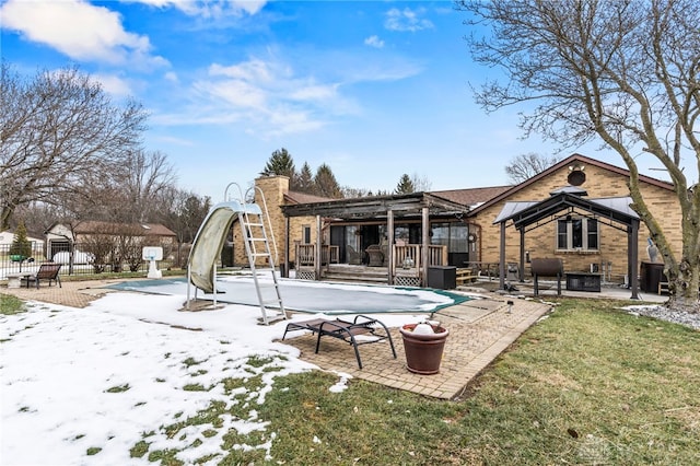 rear view of property featuring a lawn, a covered pool, a patio, and central air condition unit